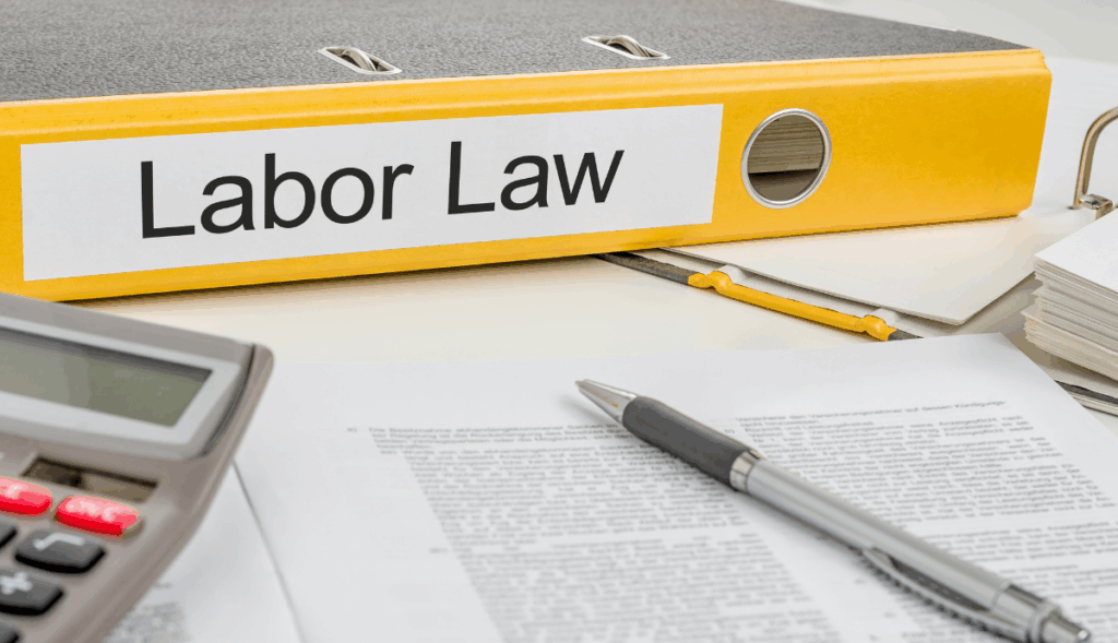 Dossier de direito laboral com documentos e calculadora, relacionado com as 40 horas anuais de formação obrigatória em Portugal